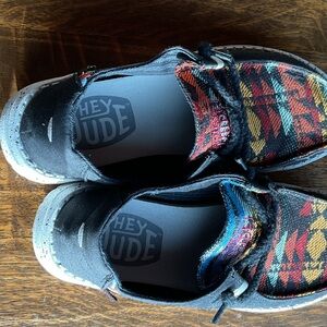 Hey Dude women’s Black Slip-On Sneakers with Multicolor Plaid Accents